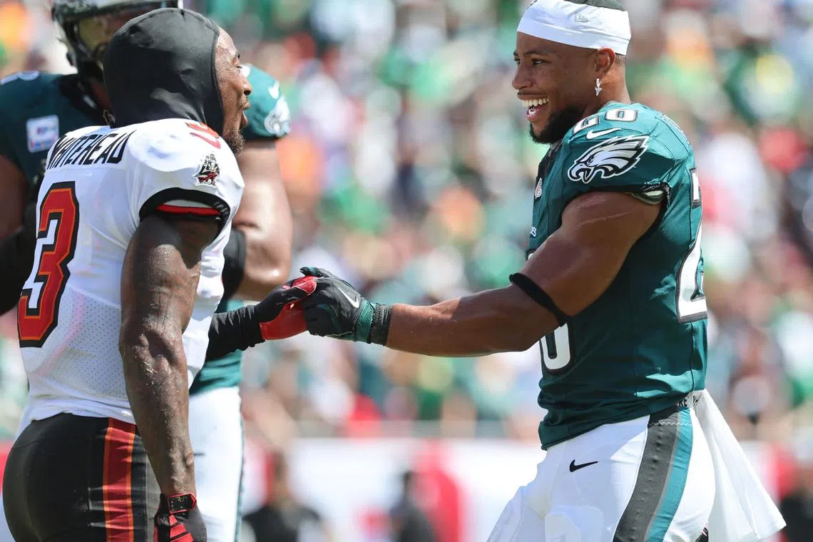 Sep 29, 2024; Tampa, Florida, USA; Tampa Bay Buccaneers safety Jordan Whitehead (3) greets Philadelphia Eagles running back Saquon Barkley (26) during the first half at Raymond James Stadium. Mandatory Credit: Kim Klement Neitzel-Imagn Images/File Photo