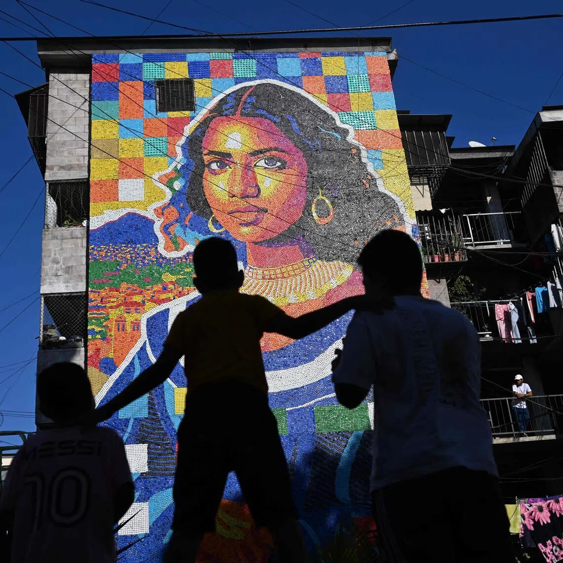 A mural made with plastic bottle caps by Venezuelan artist Oscar Olivares on an apartment building in the Zacamil neighbourhood in El Salvador.