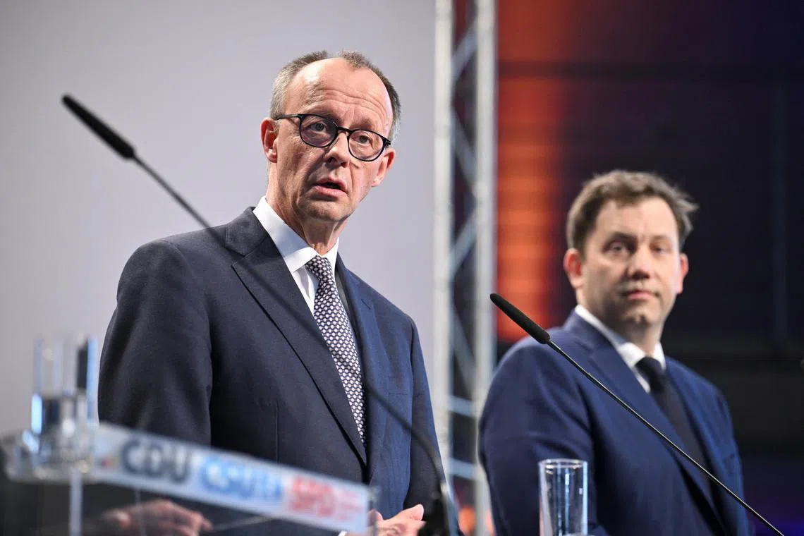 Germany's chancellor-in-waiting and leader of the Christian Democratic Union party (CDU) Friedrich Merz and co-leader of the Social Democratic party (SPD) Lars Klingbeil attend a press conference after reaching an agreement on their coalition government in Berlin, Germany, April 9, 2025. REUTERS/Annegret Hilse