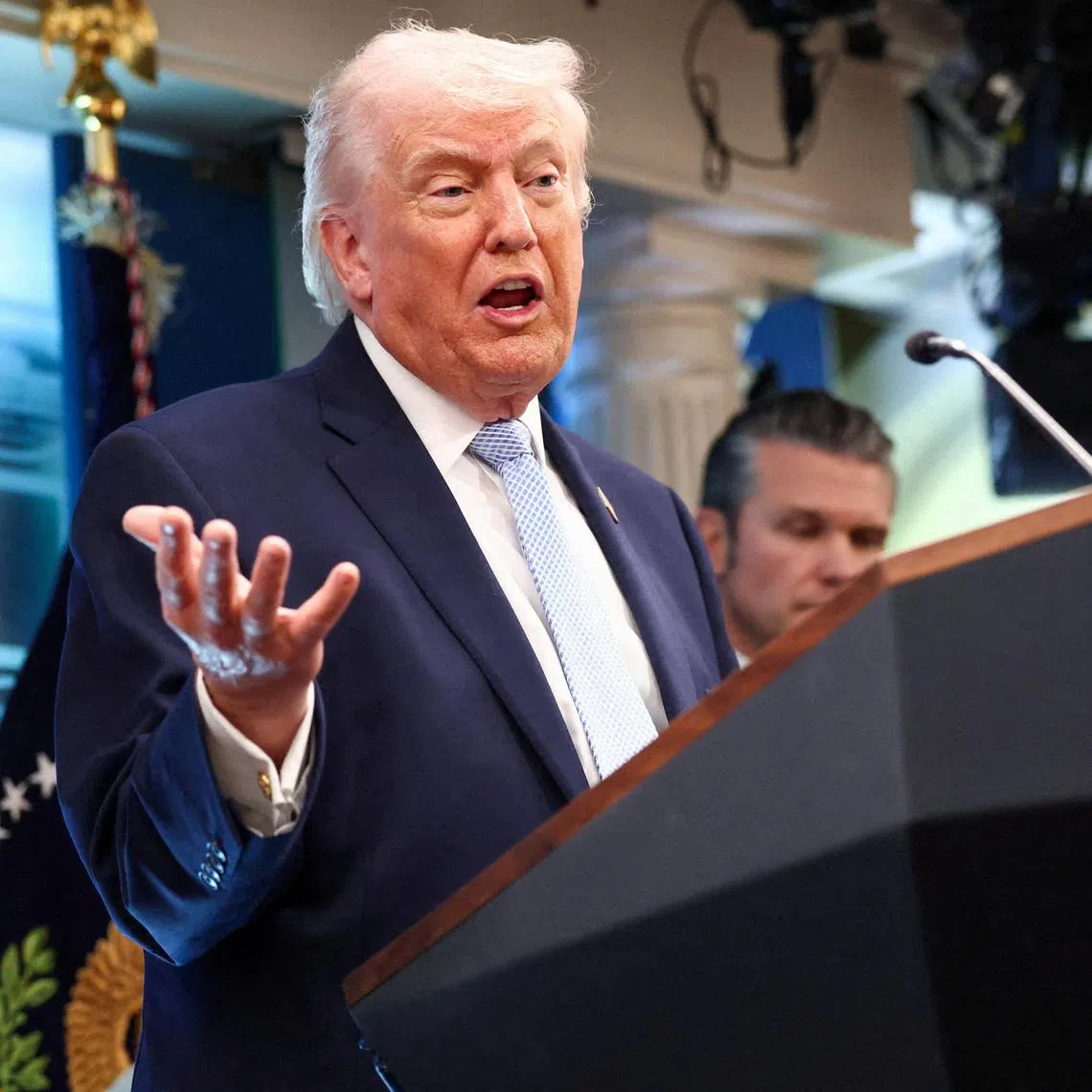 FILE PHOTO: U.S. President Donald Trump, flanked by Secretary of Defense Pete Hegseth, speaks during a press conference in the James S. Brady Press Briefing Room at the White House in Washington, D.C., U.S., April 6, 2026. REUTERS/Kevin Lamarque/File Photo