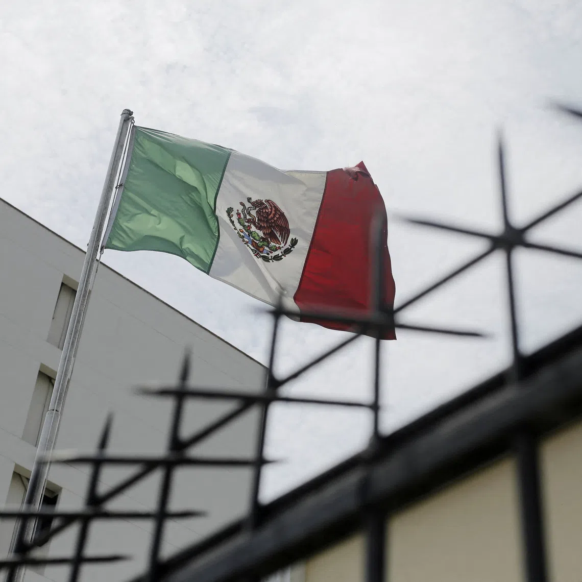 FILE PHOTO: A Mexican flag flutters at Mexico’s embassy in Lima in Peru, November 5, 2025. REUTERS/Gerardo Marin/ File Photo
