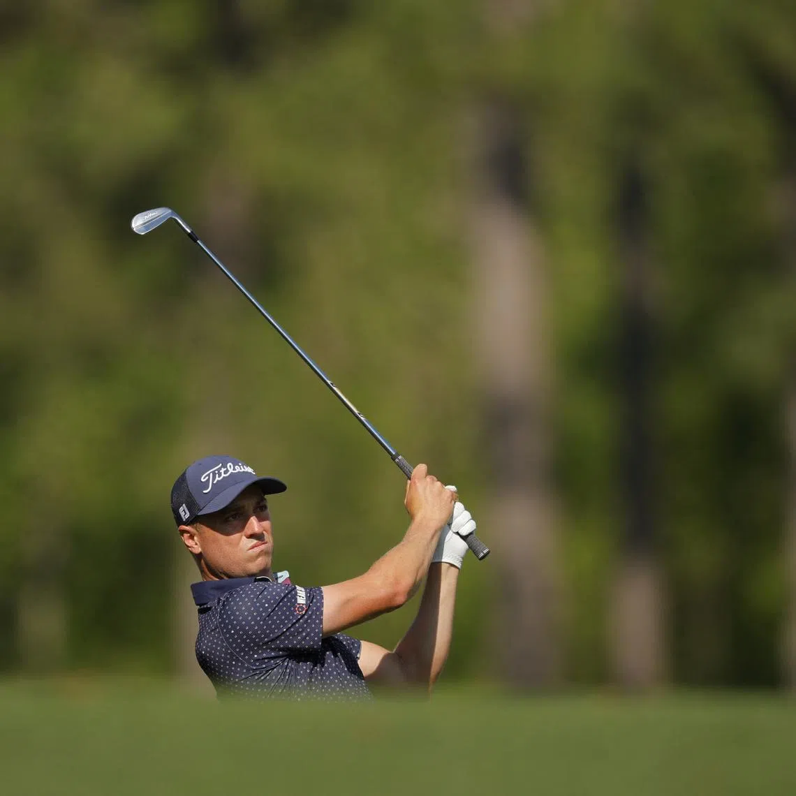 FILE PHOTO: Golf - The Masters - Augusta National Golf Club, Augusta, Georgia, U.S. - April 11, 2025 Justin Thomas of the U.S. hits his tee shot on the 12th hole during the second round REUTERS/Mike Blake/File Photo