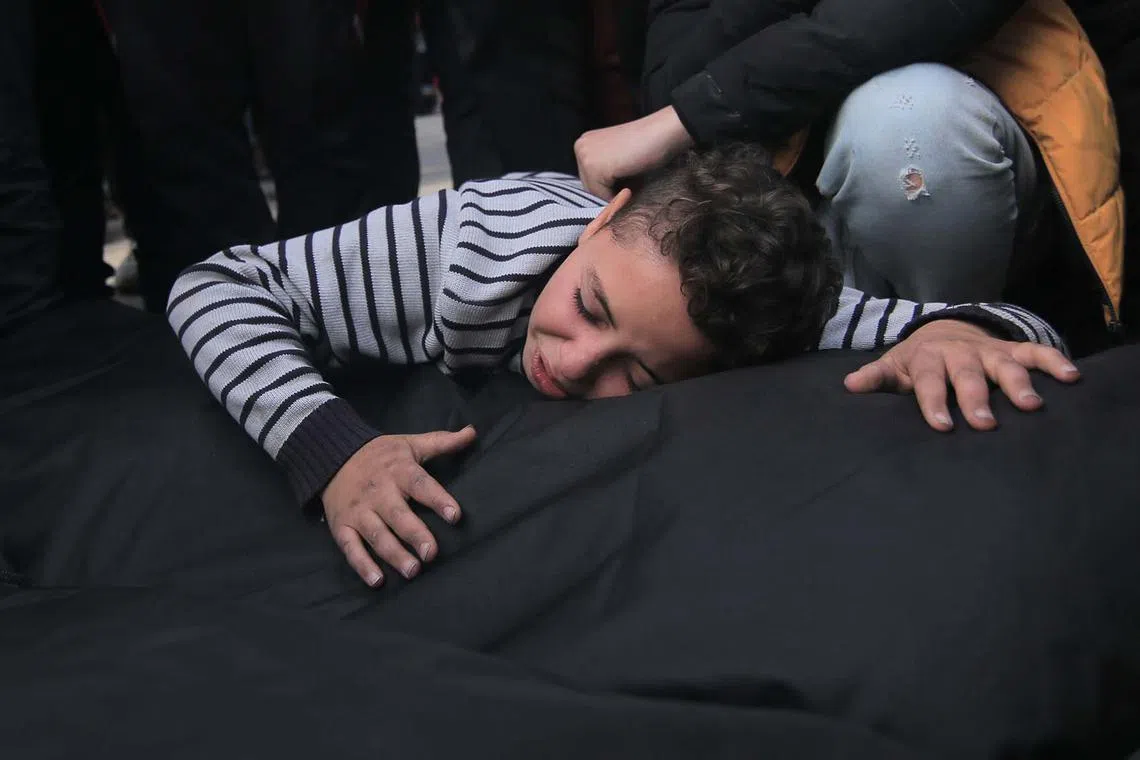 (EDITORS NOTE: Image depicts death.) A Palestinians boy mourns a relative killed during Israeli bombardment outside the morgue at the Nasser Medical hospital in Khan Younis, southern Gaza, on Wednesday, Dec. 20, 2023. Israeli President Isaac Herzog said his country is prepared to agree to a second humanitarian pause in fighting in exchange for the return of more hostages held by Hamas. Photographer: Ahmad Salem/Bloomberg