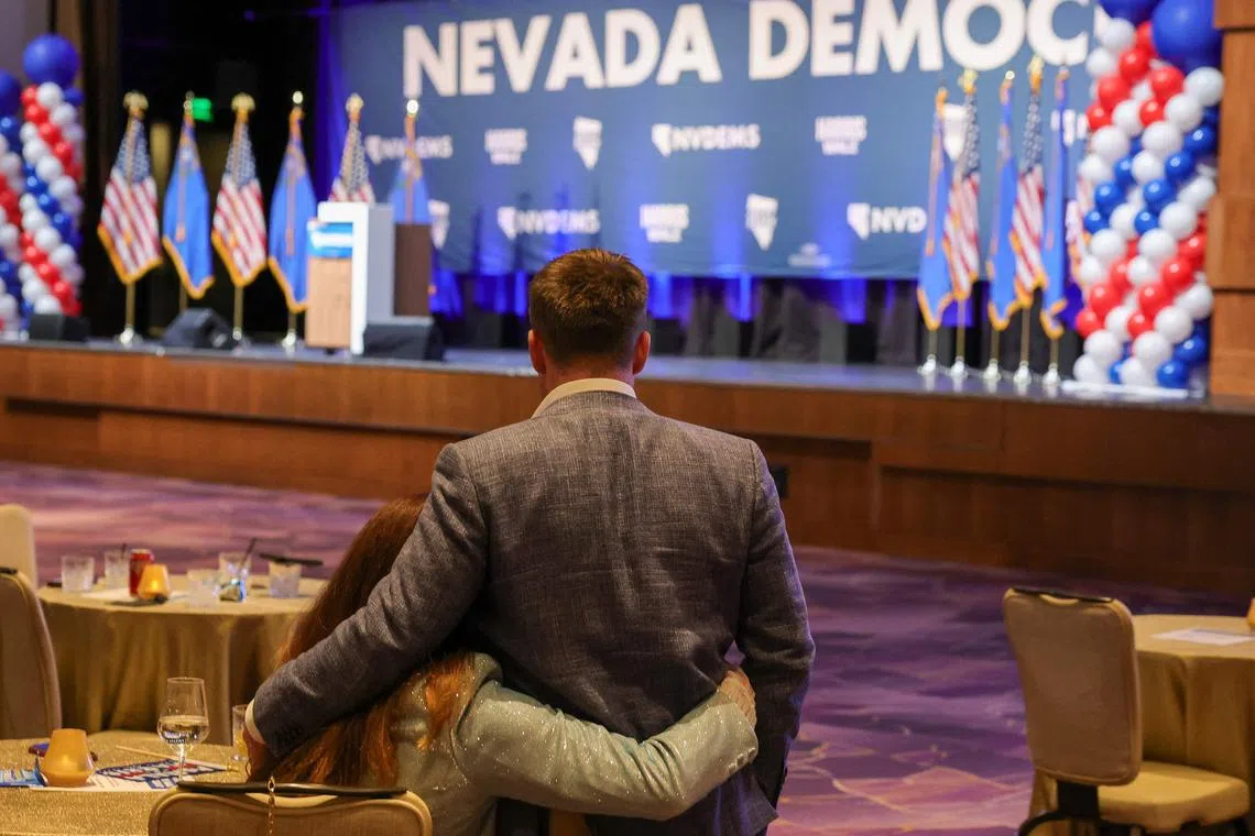 Democratic Party members embrace at a watch party in Las Vegas, as vote tallies show Donald Trump winning the Nov 5 eleciton.