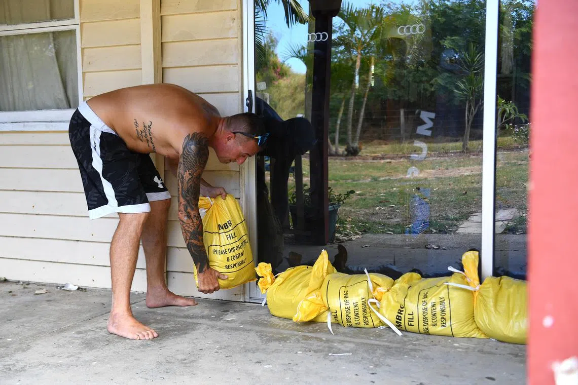 Resident Jon Wadey sandbags his house on Bribie Island, Brisbane, Australia, on March 4.
