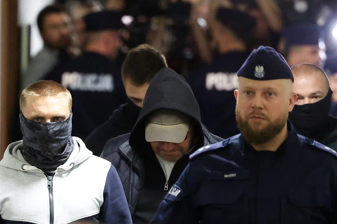 A Ukrainian diver, Volodymyr Z., who is wanted by Germany over his alleged involvement in the 2022 explosions that damaged the Nord Stream pipeline and severely disrupted Russian gas supplies to Europe, walks escorted by Polish Police at the district court in Warsaw, Poland, October 1, 2025. REUTERS/Kacper Pempel