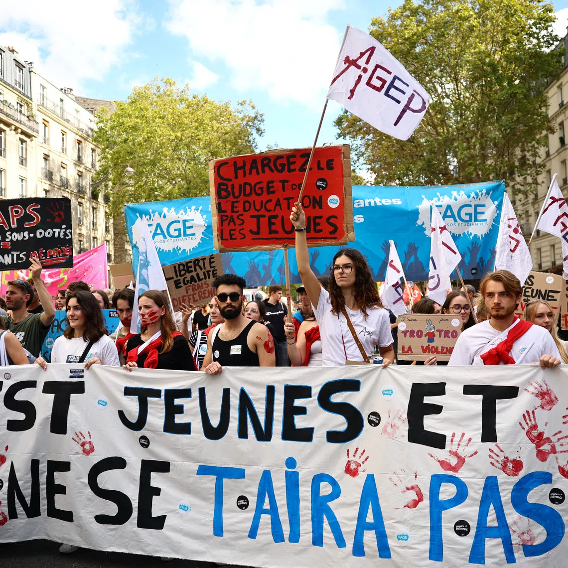 Protesters hold a banner reading \"We are young, and we won't stay silent\" during a demonstration by French high school and university students in Paris as part of a nationwide protest movement led by students, supported by teachers, school parents and labour unions, demanding better school conditions and concrete measures, France, October 13, 2026.   REUTERS/Sarah Meyssonnier
