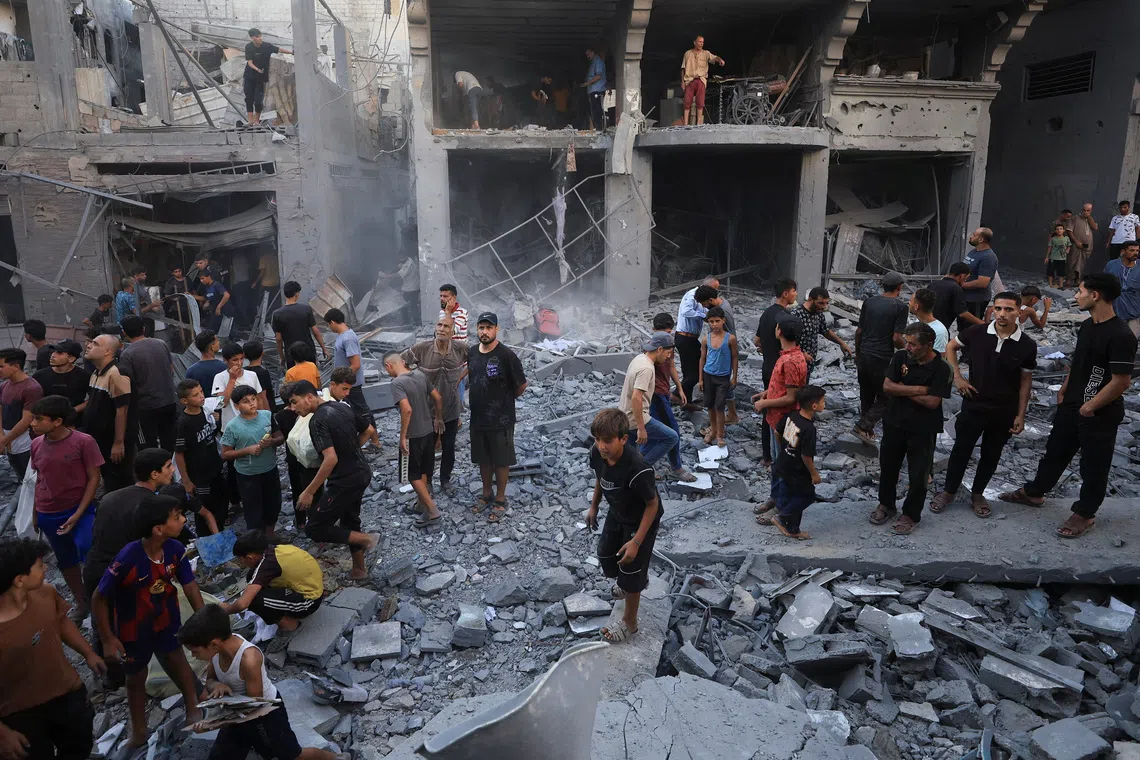 Palestinians inspect the site of an Israeli strike on a house, carried out after the Israeli military warned residents to evacuate the area, at al-Shati (Beach) refugee camp, in Gaza City, August 24, 2026. REUTERS/Dawoud Abu Alkas