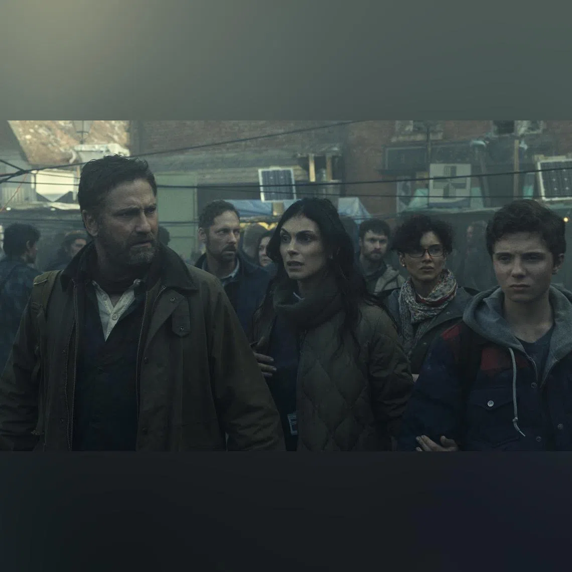 (Foreground, from left) Gerard Butler, Morena Baccarin and Roman Griffin Davis in Greenland 2: Migration. 