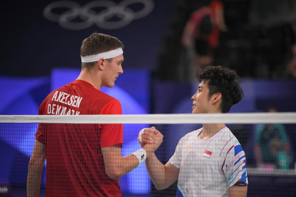 Singaporean shuttler Loh Kean Yew shakes hands with Denmark’s Viktor Axelsenafter the Paris 2024 Olympic Badminton Men’s quarter final on Aug 2.