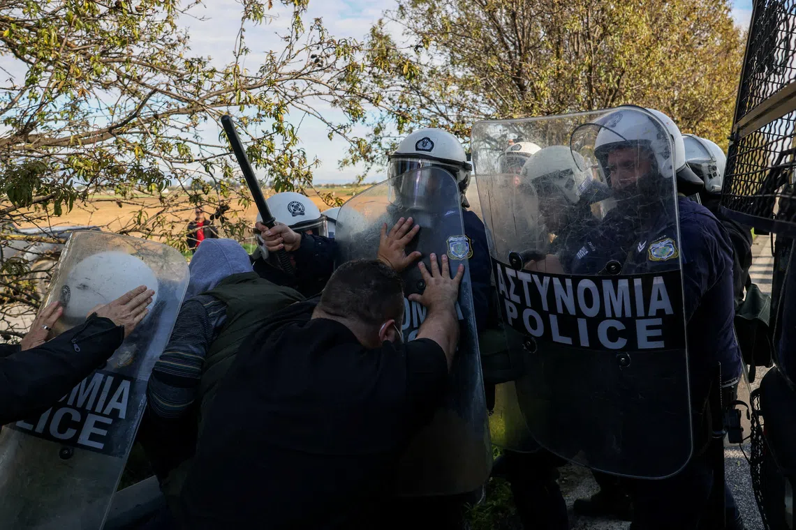 Protesting farmers push against riot police in Nikaia, near Larissa, Greece, November 30, 2025. REUTERS/Alexandros Avramidis