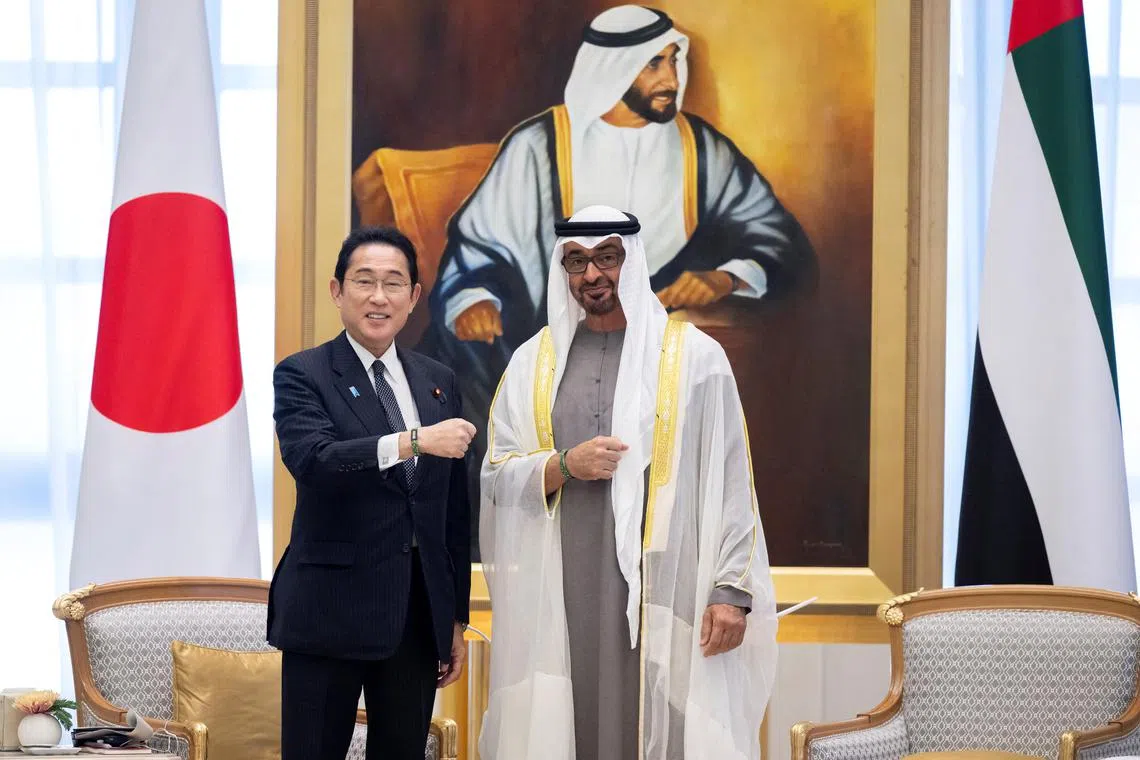 Sheikh Mohamed bin Zayed Al Nahyan, President of the United Arab Emirates and Fumio Kishida, Prime Minister of Japan, stand for a photograph wearing a 2023 UN Climate Change Conference (COP28) wristband during an official reception at Qasr Al Watan, Abu Dhabi, United Arab Emirates, July 17, 2023. Abdulla Al Neyadi / UAE Presidential Court/Handout via REUTERS  THIS IMAGE HAS BEEN SUPPLIED BY A THIRD PARTY

