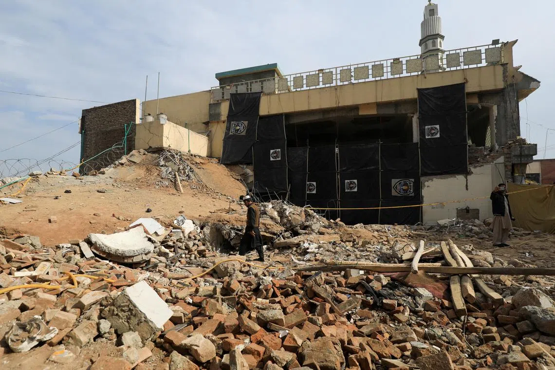 FILE PHOTO: A man walks amid the rubble, days after a suicide blast in a mosque in Peshawar, Pakistan February 2, 2023. REUTERS/Fayaz Aziz/File Photo