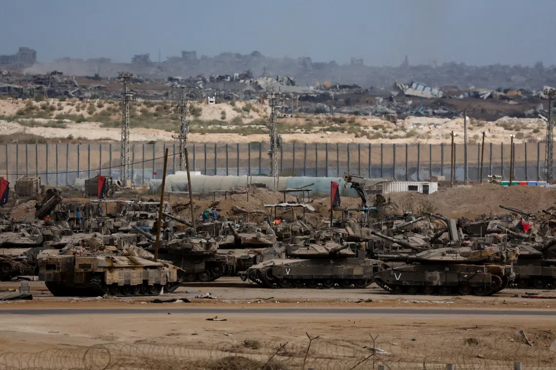 Israeli tanks sit, after U.S. President Donald Trump announced that Israel and Hamas agreed on the first phase of a Gaza ceasefire, on the Israeli side of the border with Gaza, October 9, 2025. REUTERS/Ammar Awad