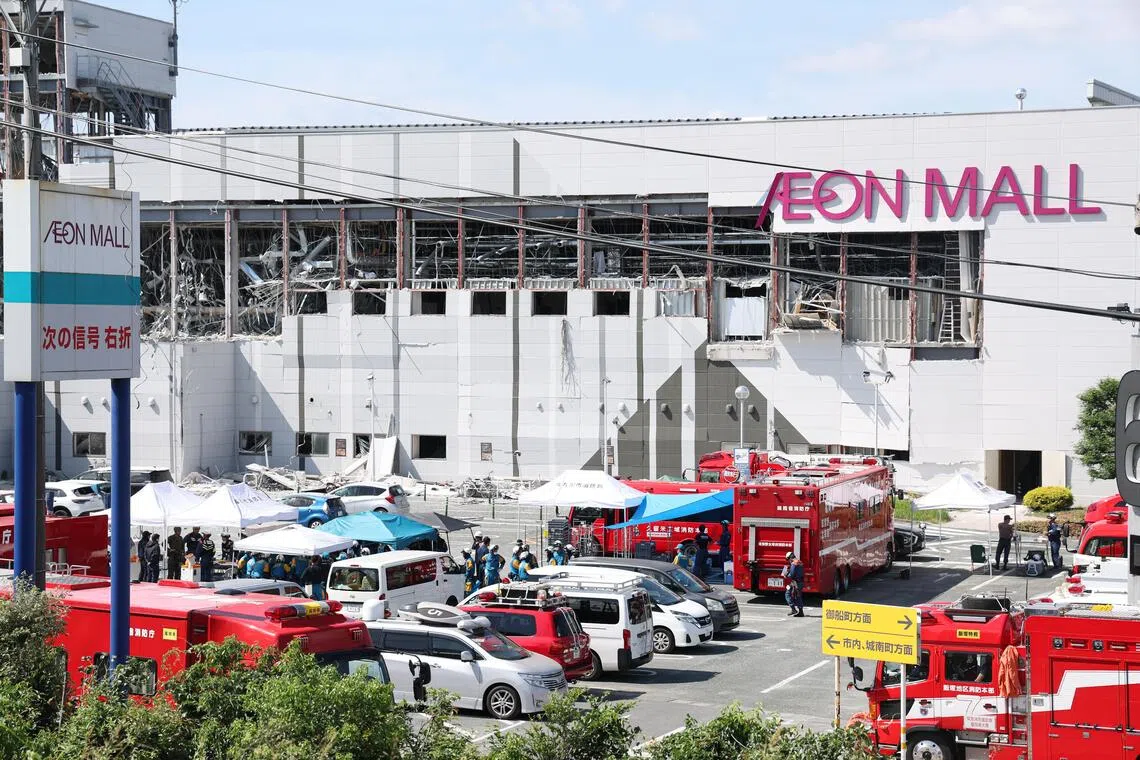 Rescuers conduct search operations at the Aeon Mall Kumamoto building which was damaged by an explosion following a powerful earthquake.