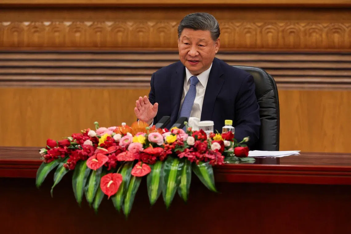 Chinese President Xi Jinping speaks during a meeting with foreign business leaders at the Great Hall of the People in Beijing, China March 28, 2025. REUTERS/Florence Lo