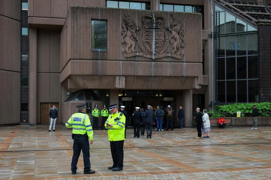 Police officers stand outside the entrance of the Liverpool Magistrates' Court, on the day Paul Doyle, the 53-year old charged with multiple offences including dangerous driving and causing grievous bodily harm after a car drove into a crowd at Liverpool FC's trophy parade, appears at court, in Liverpool, Britain, May 30, 2025. REUTERS/Phil Noble
