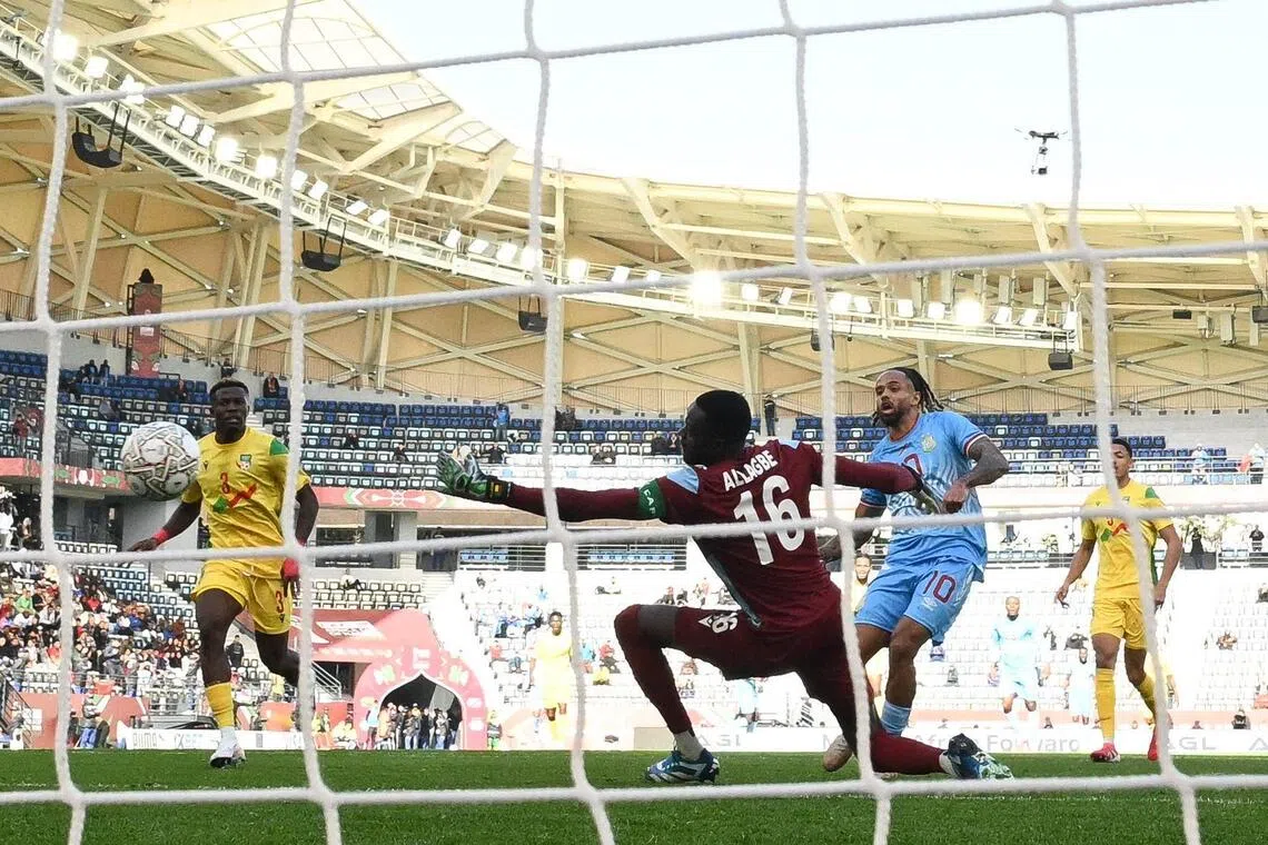 Democratic Republic Of Congo's forward Theo Bongonda scores the game's only goal past Benin's goalkeeper Saturnin Allagbe in their Africa Cup of Nations Group D football match at Al Medina Stadium in Rabat on Dec 23, 2025.