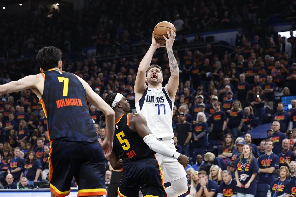 Dallas Mavericks guard Luka Doncic shoots against Oklahoma City Thunder guard Luguentz Dort during the second half of Game 5 of the NBA Western Conference semi-finals.