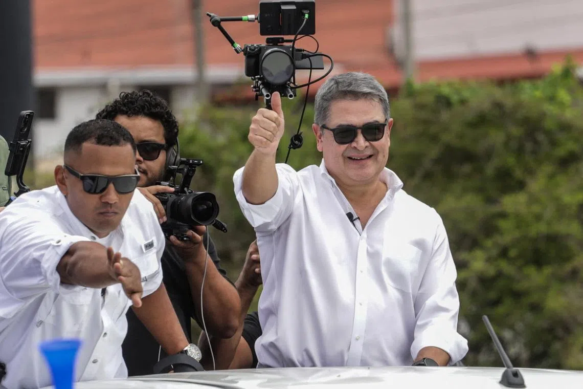Former Honduran President Juan Orlando Hernandez gives a thumbs up from a vehicle upon his arrival at Palmerola International Airport following a pardon by U.S. President Donald Trump, which freed Hernandez from a 45-year prison sentence for conspiring to import cocaine into the United States, near Comayagua, Honduras, July 26, 2026. REUTERS/Fredy Rodriguez