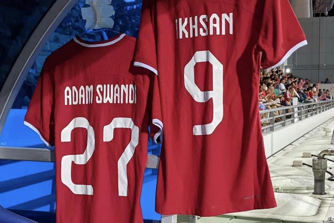 The jerseys of Adam Swandi and Ikhsan Fandi, who are both injured, hung on the Lions' substitutes bench during their 0-0 draw with Vietnam on Friday.