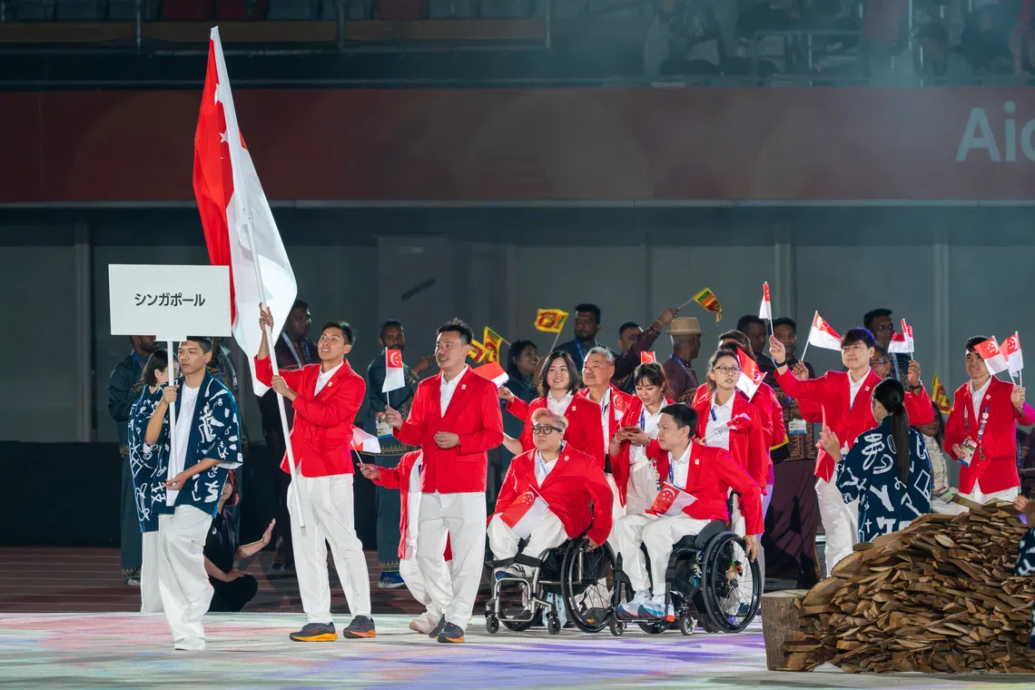Team Singapore, with para-sprinter James Ang as flag bearer, at the 2026 Asian Para Games opening ceremony.