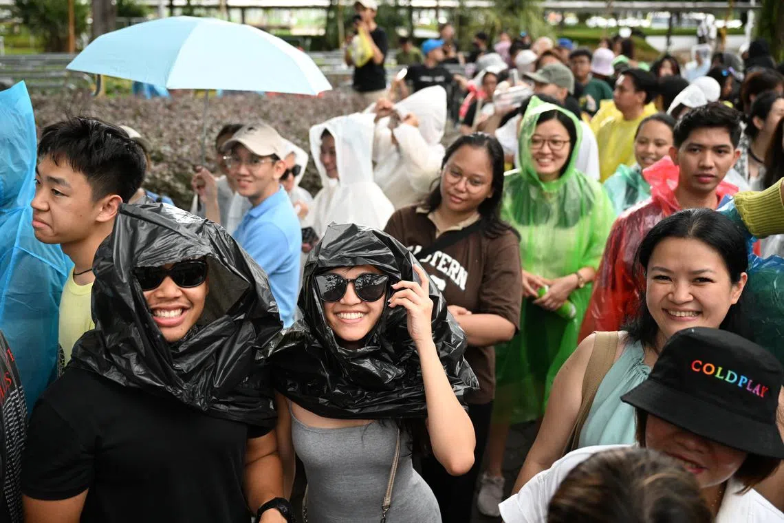 Fans braving the rain as they queued to enter the National Stadium for British band Coldplay’s concert on Jan 23, 2024.