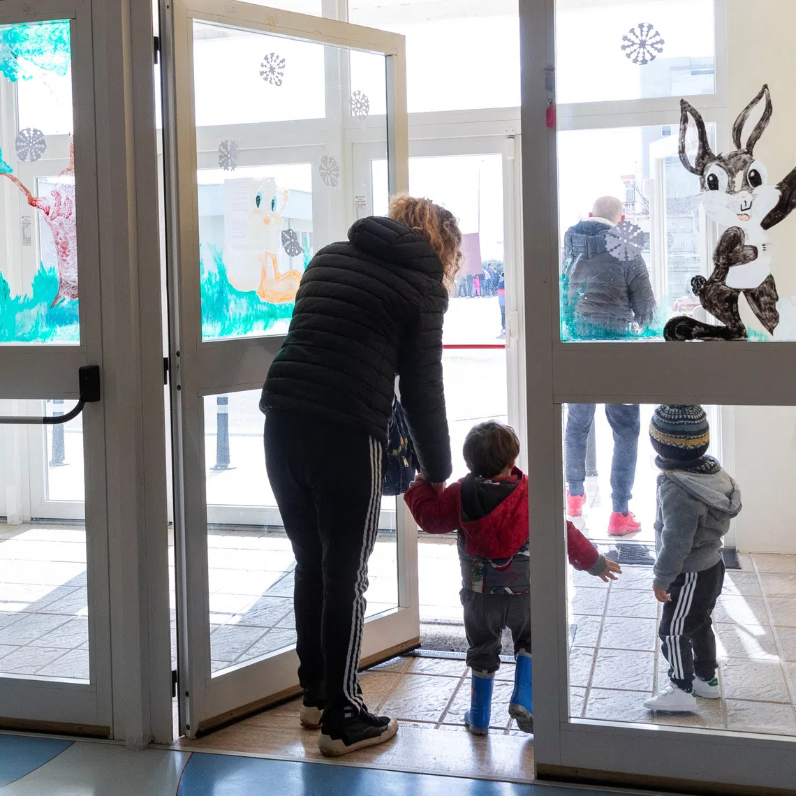 People pick their children up from the nursery in Cisternino, Italy February 13, 2025. REUTERS/Alessandro Garofalo