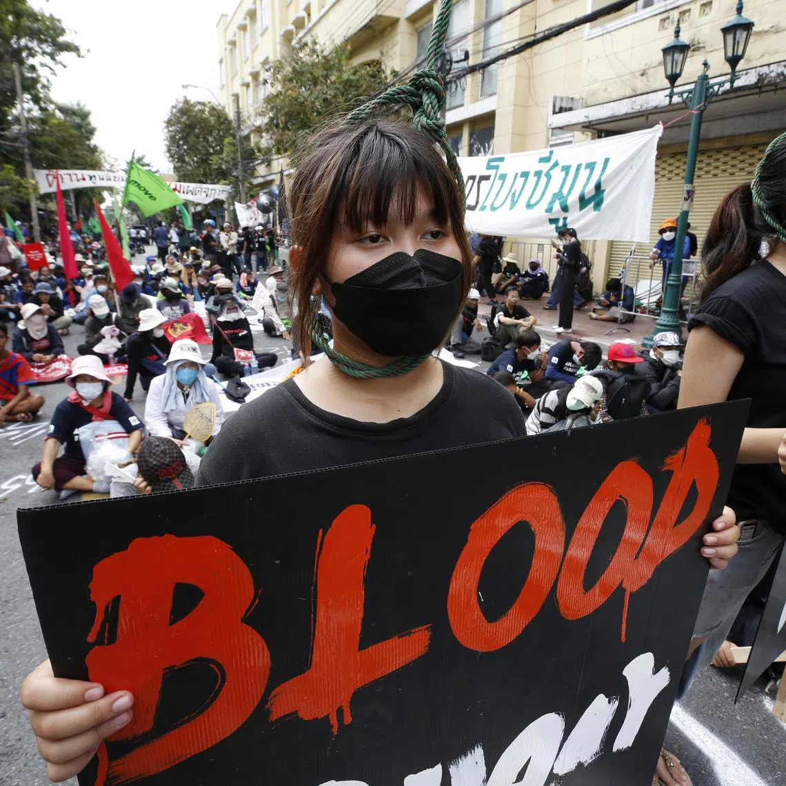 epa10312039 Anti-government protesters hold placards while wearing nooses around their necks during a protest against the APEC 2022 summit in Bangkok, Thailand, 18 November 2022. Anti-government protesters held a demonstration calling for the resignation of Thai Prime Minister Prayut Chan-o-cha as Thailand hosts the Asia-Pacific Economic Cooperation or APEC 2022, the summit for economic cooperation comprising 21 leading member economies.  EPA-EFE/NARONG SANGNAK