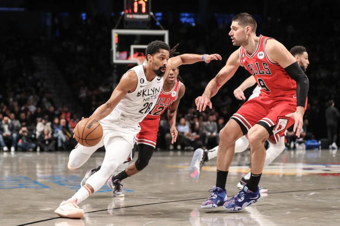 Brooklyn Nets guard Spencer Dinwiddie (in white) looks to drive past Chicago Bulls centre Nikola Vucevic (No. 9) on Thursday. 