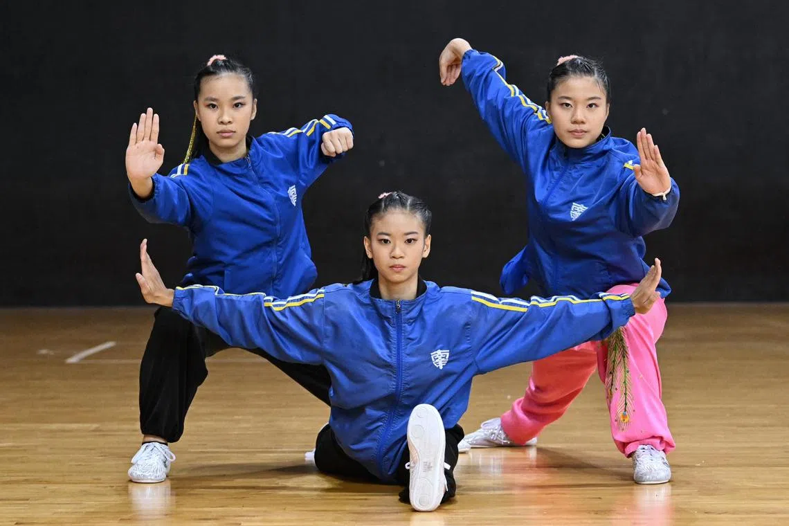 From left: Nanyang Girls' High School's Heidi Kong, Lyvia Phua and Zhuo Kaiqian helped their school shine at the National School Games' wushu competition.