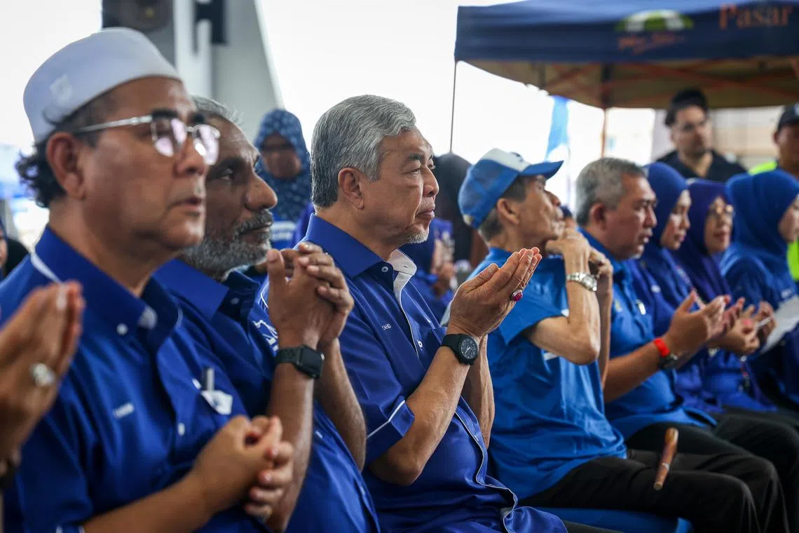 2022年马来西亚大选、马国第15届全国大选竞选期间，国阵及巫统主席阿末扎希（左三）于11月12日走访自己的选区峇眼拿督时参加祷告。