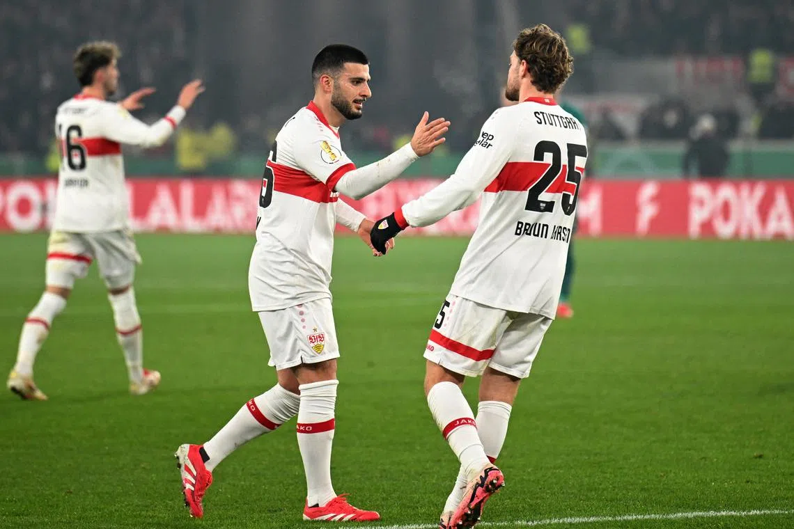 FILE PHOTO: Soccer Football - DFB Cup - Quarter Final - VfB Stuttgart v FC Augsburg - MHPArena, Stuttgart, Germany - February 4, 2025 VfB Stuttgart's Deniz Undav celebrates scoring their first goal with Jacub Bruun Larsen REUTERS/Angelika Warmuth/File Photo