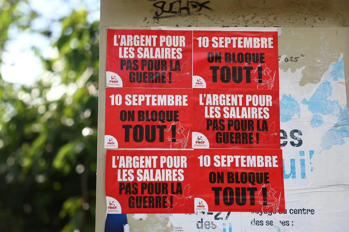 Posters with the slogans \"September 10, we block everything !\" and \"Money for wages, not for war !\" are seen on a wall in Paris, the day before a grassroots protest movement called \"Bloquons Tout\" (\"Let's Block Everything\") is calling for nationwide all-day disruption, France, September 9, 2025. REUTERS/Abdul Saboor