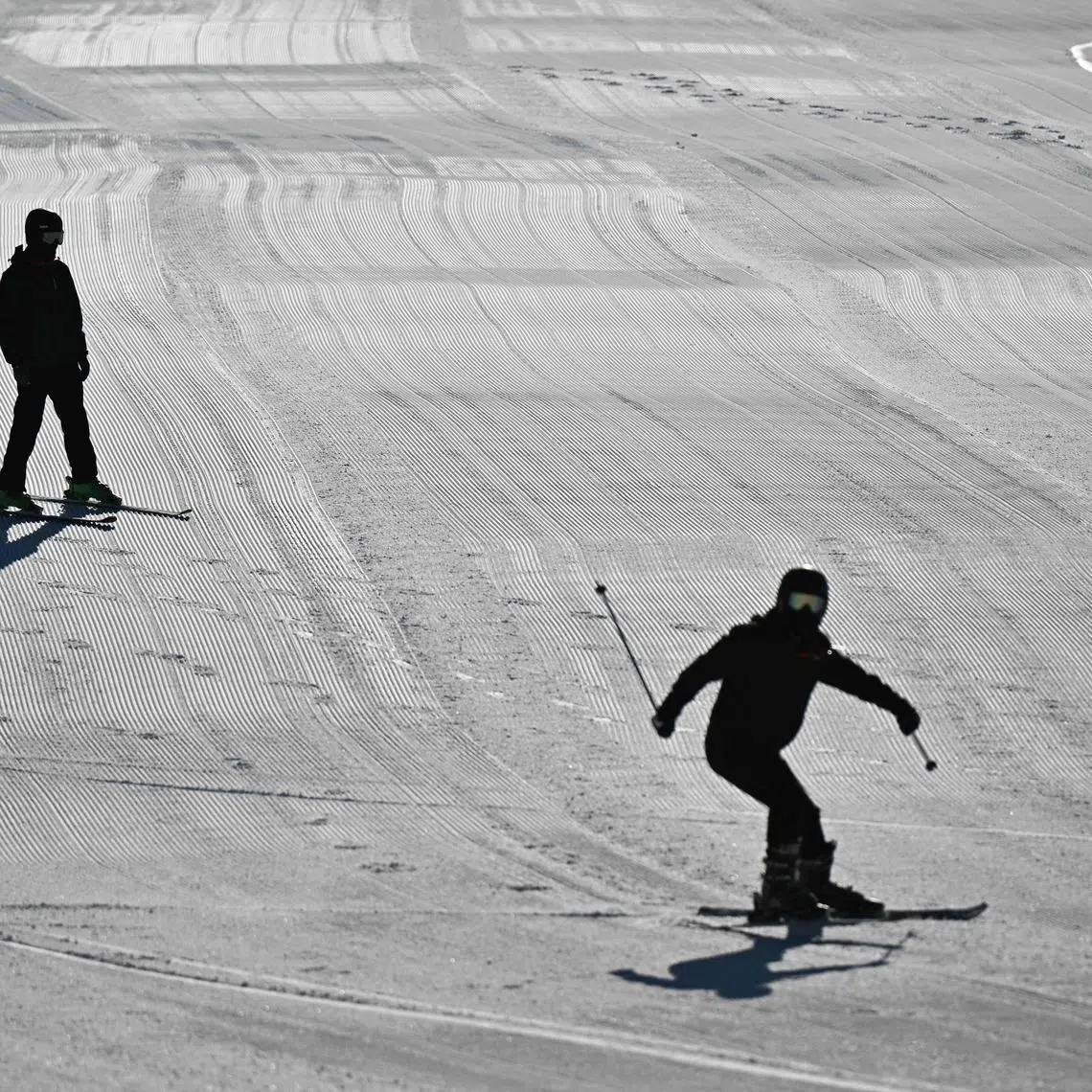 Visitors skiing on the downhill slopes at Lianhuashan Ski Resort on the outskirts of Beijing on Feb 16.