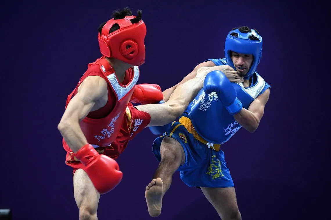 South Korea's Hong Min-jun and Alsendi Tharwt Mahyoub Ali Naiji from Yemen during the sanda men's 56kg quarter-finals at the Asian Games.