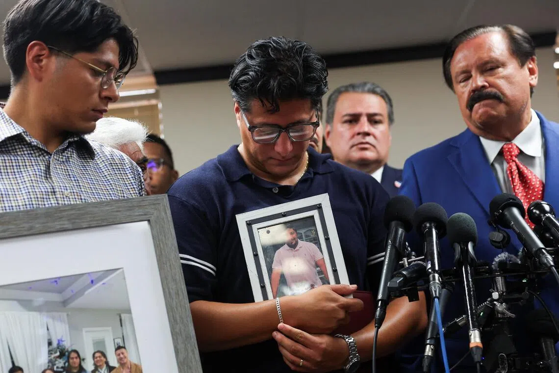 Ronaldo Salgado holds a picture of his father Lorenzo Salgado Araujo, who was fatally shot by an ICE agent, during a news conference in Houston, on July 8.