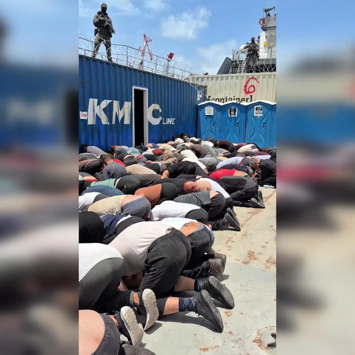 A screen grab taken from footage released on X in May by Israel's National Security Minister Itamar Ben Gvir showing dozens of detained flotilla activists kneeling with their hands tied behind their backs and their foreheads on the ground on the deck of an Israeli military boat.
