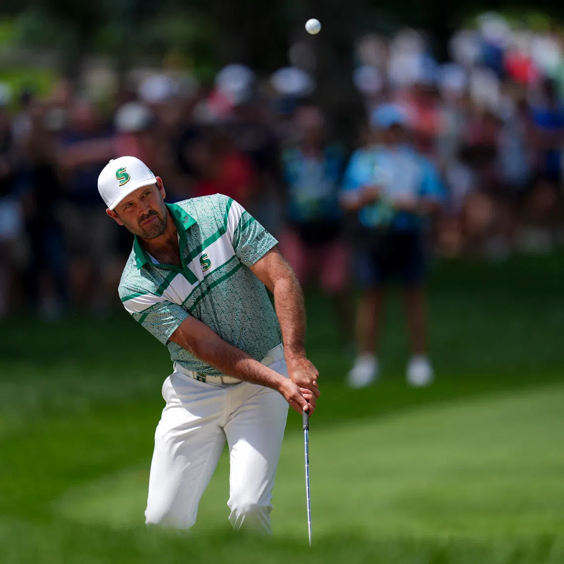 Aug 24, 2025; Detroit, Michigan, USA; Charl Schwartzel of Stinger GC chips onto the first green during the finals of the LIV Golf Michigan Team Championship at The Cardinal at Saint John's Resort. Mandatory Credit: Aaron Doster-Imagn Images