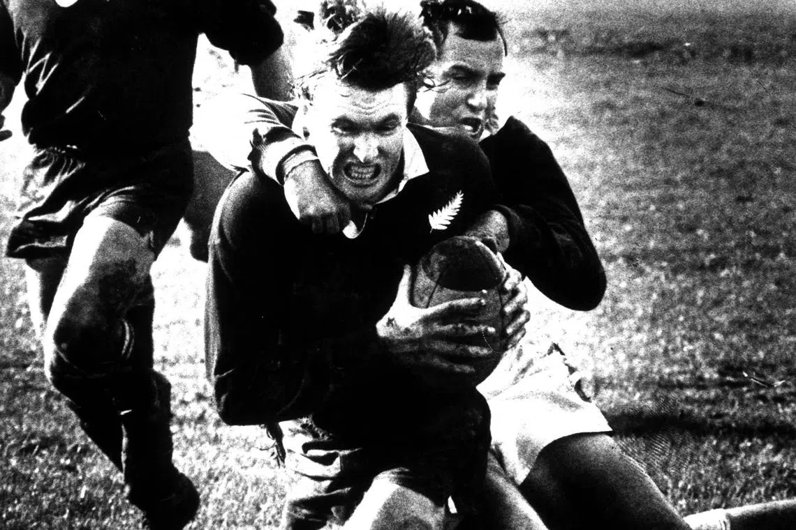 New Zealand's Stu Wilson scoring a try as South Africa's Gysie Pienaar tackles him in the first rugby test match at Lancaster Park, Christchurch on Aug 15, 1981.