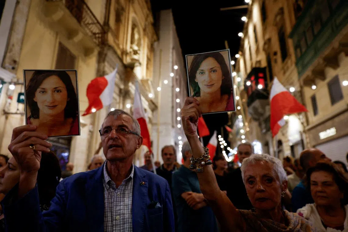 FILE PHOTO: People hold up photos of late anti-corruption journalist Daphne Caruana Galizia during a protest march on the sixth anniversary of her assassination, in Valletta, Malta October 16, 2023. REUTERS/Darrin Zammit Lupi/File Photo