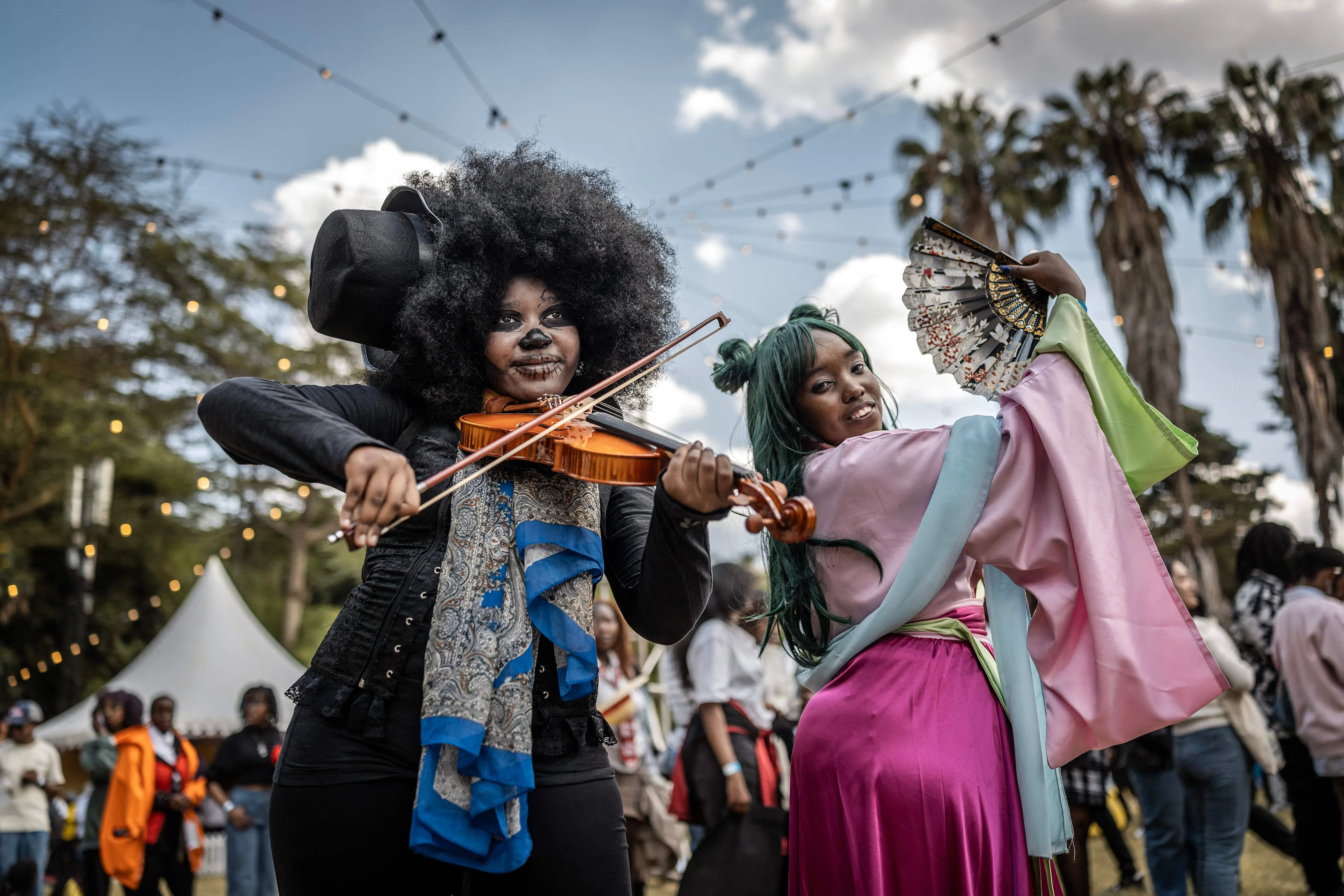TOPSHOT - Cosplayers and Japanese culture fans pose for social media content during the Otamatsuri convention in Nairobi on August 22, 2026. Enthusiasm for the cosplay world is growing in Kenya, where more than 4,000 people attended the Otamatsuri convention in the capital on August 22, 2026. The annual gathering, held since 2019, brings together fans of anime, video games and manga and culminates in a cosplay competition.The event is a parade of characters from manga series such as One Piece and Naruto, among others, whose character arcs inspire cosplayers with themes of perseverance and rebirth, they explain, while noting that their community is still often misunderstood in Kenya. (Photo by Luis TATO / AFP)