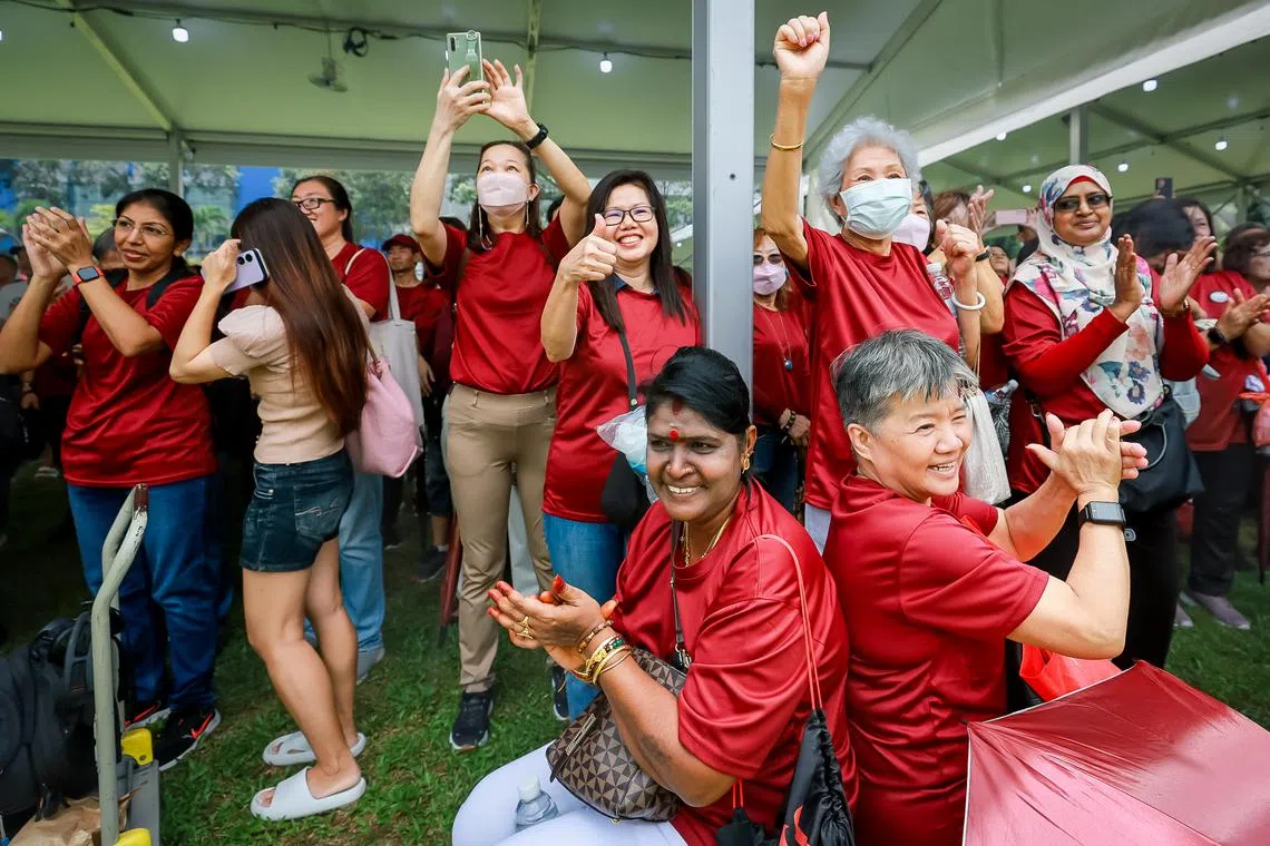 Supporters of Tharman Shanmugaratnam clapping and cheering. 