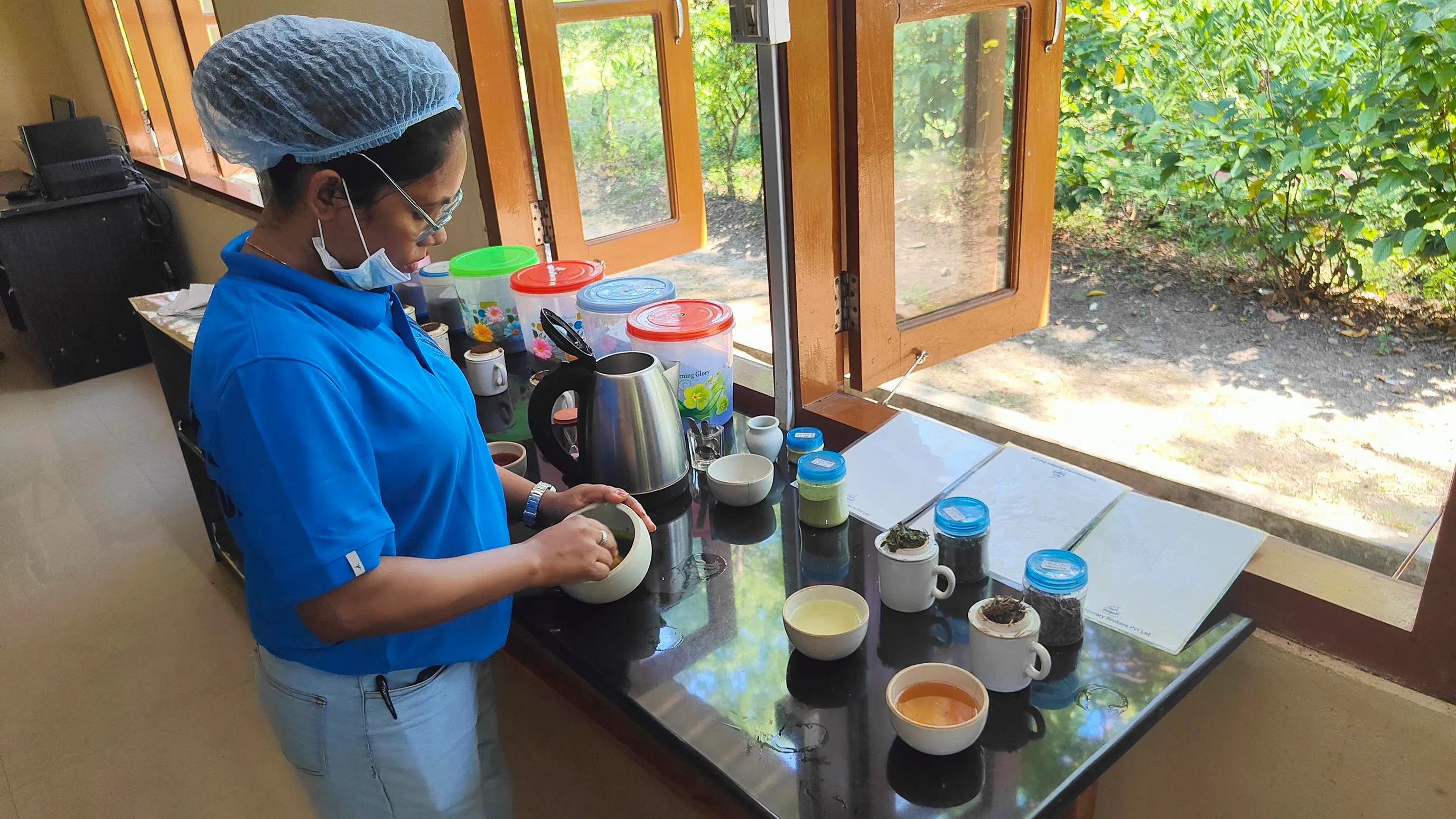 A worker preparing matcha at Chota Tingrai.