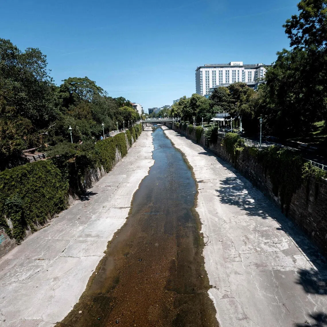 A very low water level of the river Wienfluss (Vienna river) cutting through the City park (Stadtpark) is seen on a sunny and hot day in Vienna, Austria, on May 28.