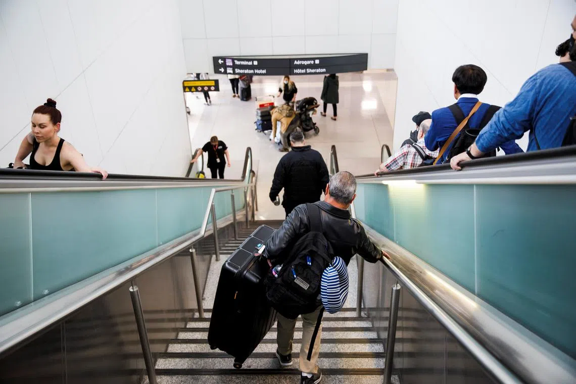 FILE PHOTO: Travellers make their way to the departures terminal at the start of the Victoria Day holiday long weekend at Toronto Pearson International Airport in Mississauga, Ontario, Canada, May 20, 2022.  REUTERS/Cole Burston/File Photo