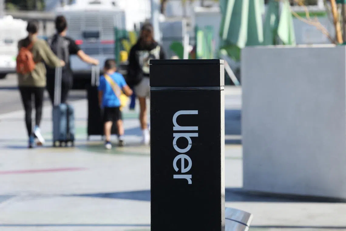 FILE PHOTO: Uber signage is posted at Los Angeles International Airport (LAX) in Los Angeles, California, U.S. July 10, 2022.  REUTERS/David Swanson/File Photo