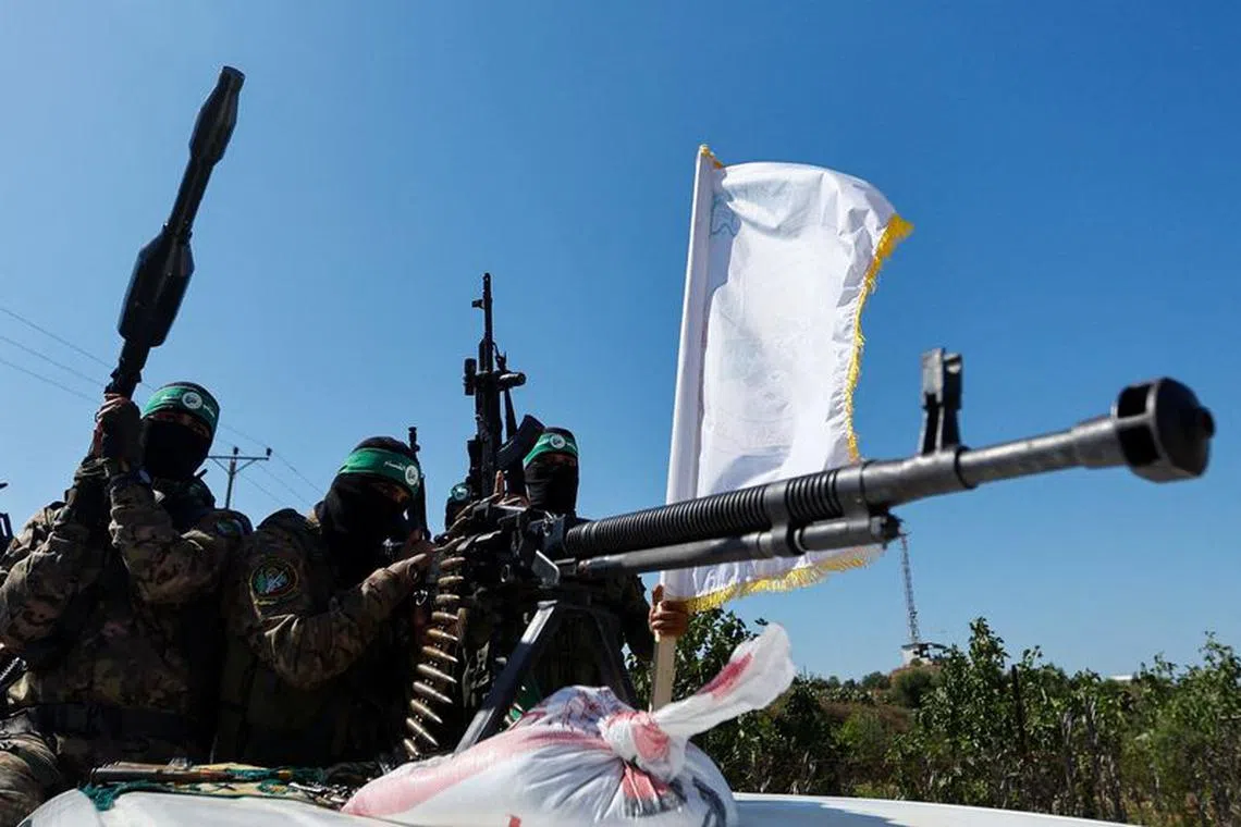 Palestinian fighters from the armed wing of Hamas take part in a military parade to mark the anniversary of the 2014 war with Israel, near the border in the central Gaza Strip, July 19, 2023. REUTERS/Ibraheem Abu Mustafa/File Photo