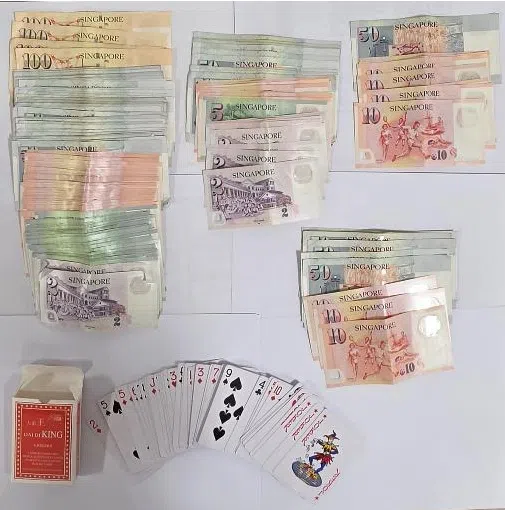 Cash and gambling-related paraphernalia seized during an anti-gambling operation in the vicinity of Yishun Street 61.