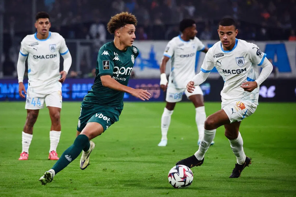 Monaco's Moroccan midfielder Eliesse Ben Seghir (left) and Marseille's English forward Mason Greenwood fight for the ball during a French Ligue 1 match.